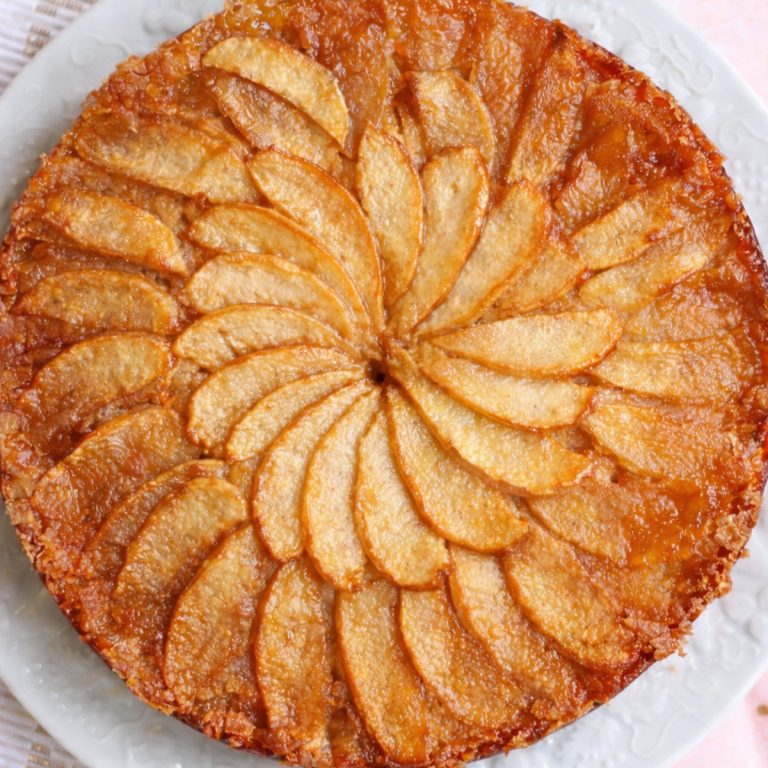 Caramelized apple cake on a white plate