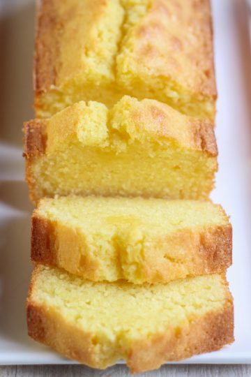 Sliced vanilla pound cake on a white platter.