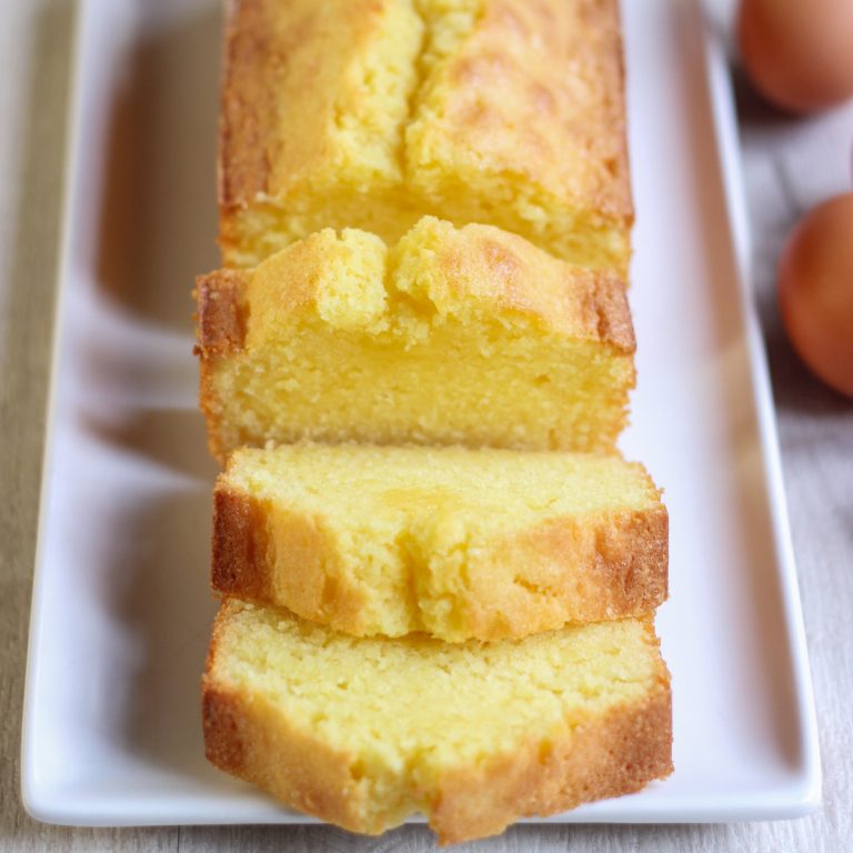 Sliced vanilla pound cake on a white platter.