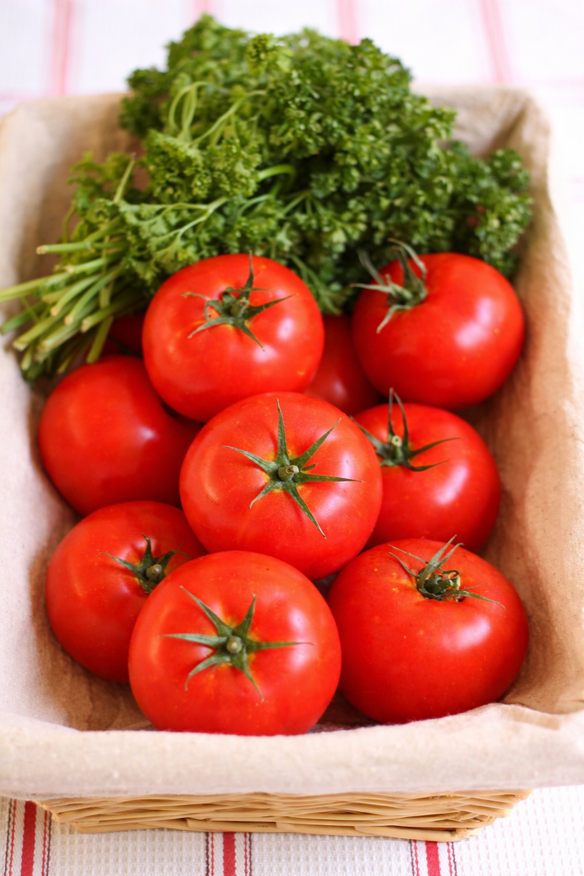 Fresh tomatoes in a basket, ready to be cooked.