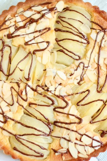 Chocolate pear tart with sliced pears baked in a soft almond filling and golden homemade tart crust.