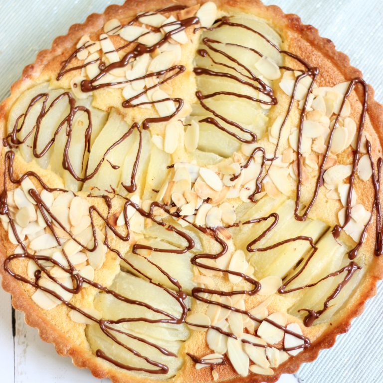 Chocolate pear tart with sliced pears baked in a soft almond filling and golden homemade tart crust.