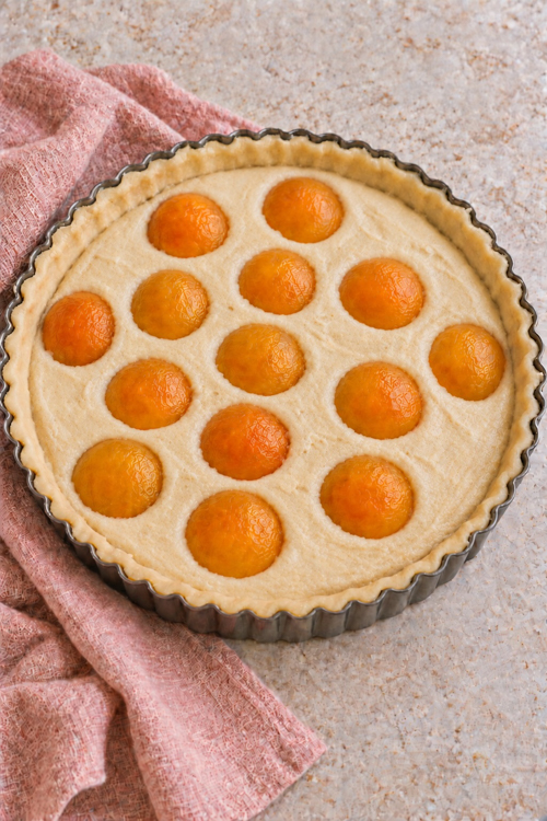 Apricot halves arranged over almond filling in an unbaked tart crust.